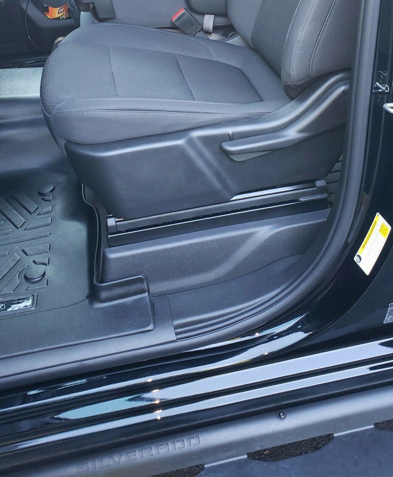 Seat lift kit installed in truck — driver side view